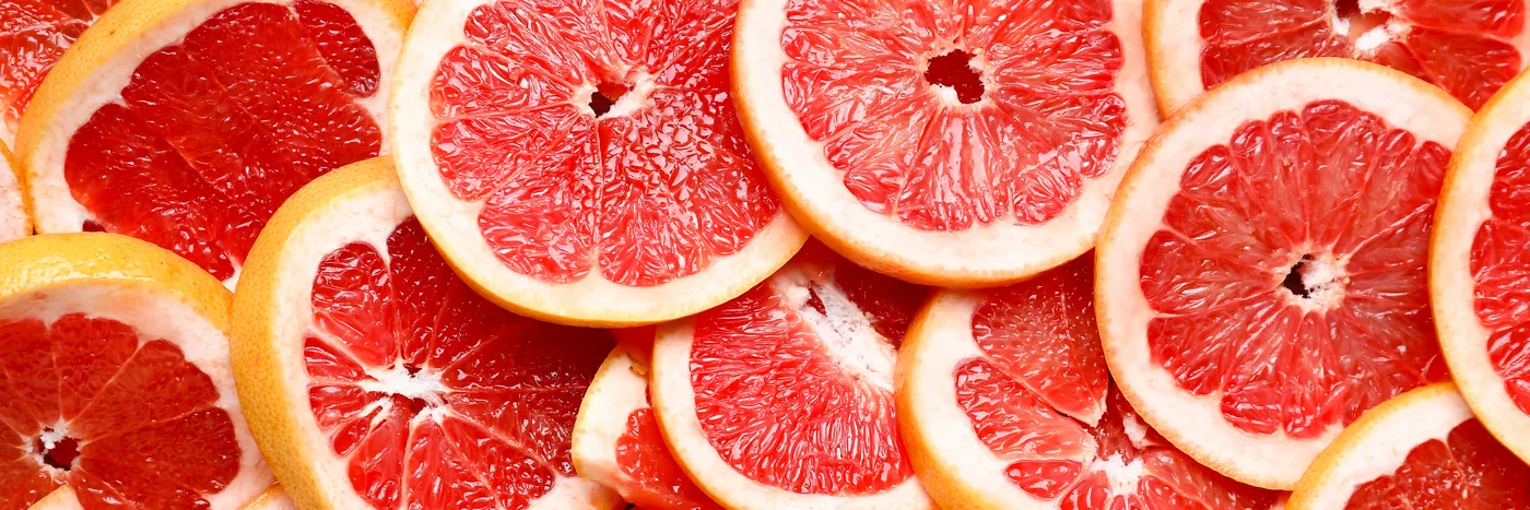 Overlapping slices of pink grapefruit filling the frame