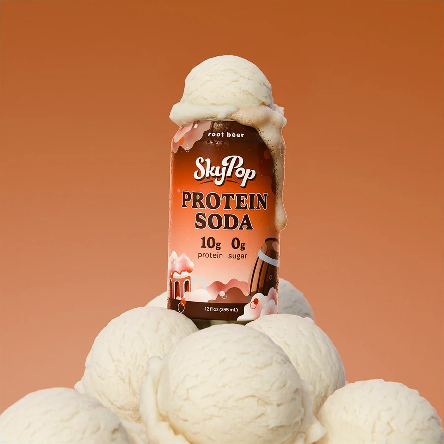 SkyPop Root Beer protein soda can standing on scoops of vanilla ice cream